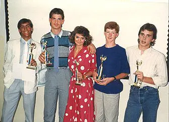 Young adults celebrating with trophies
