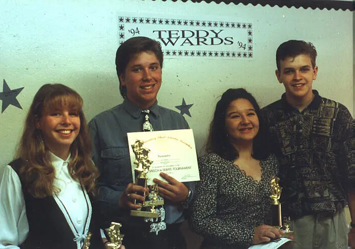 Four people celebrating award achievement