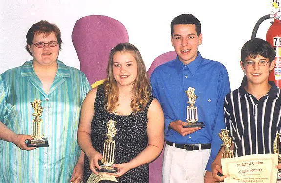 Smiling winners with awards