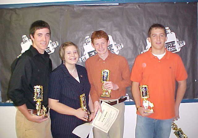Smiling teenagers with awards and certificates