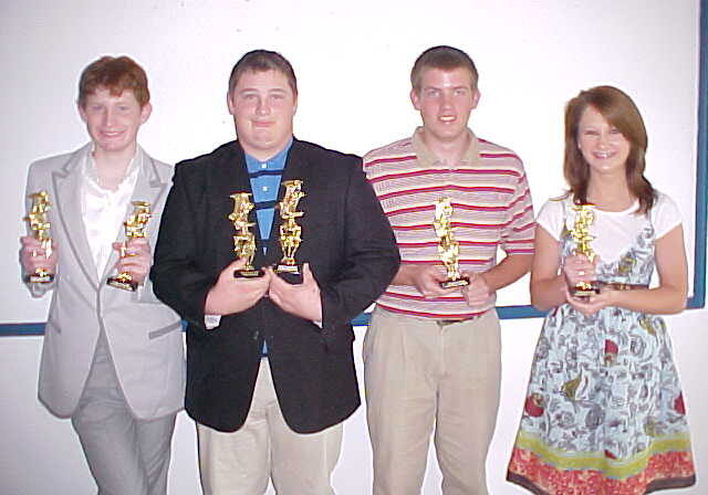 Young winners displaying trophies