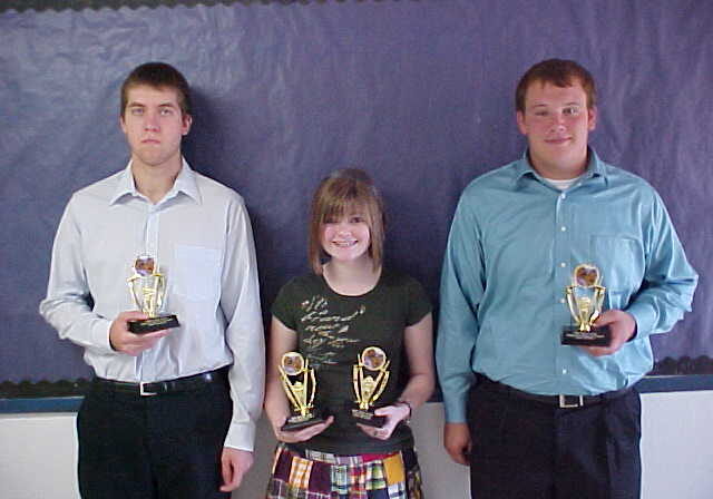 Group posing with sports trophies