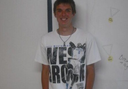 Smiling person with white graphic tee