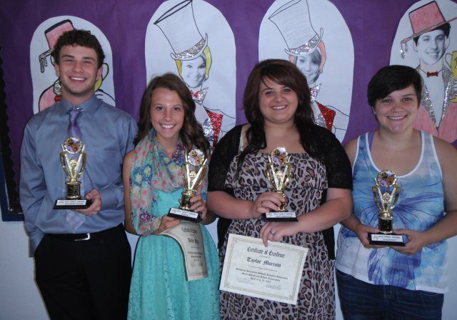 Group celebrating achievements with awards