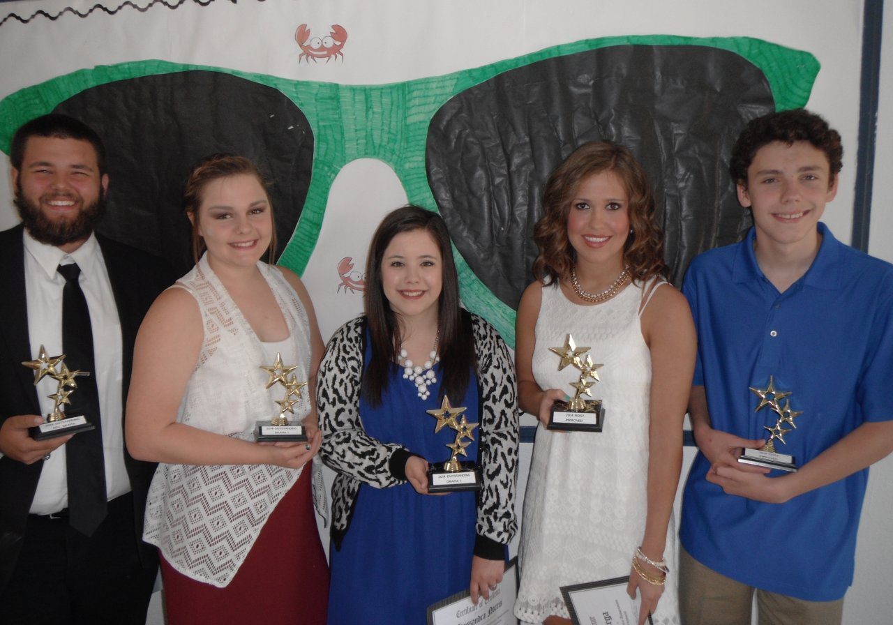 Five individuals celebrating with star trophies.