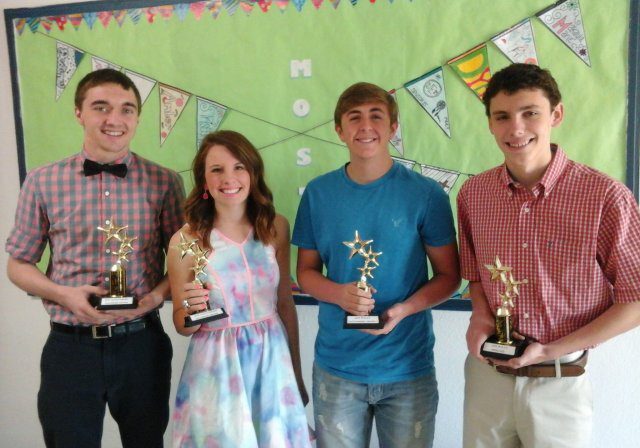 Group holding trophies against decorated background