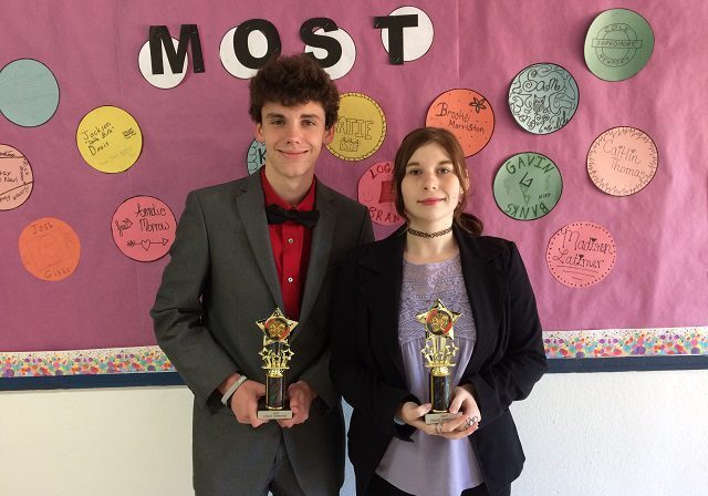 Award winners in front of decorated wall
