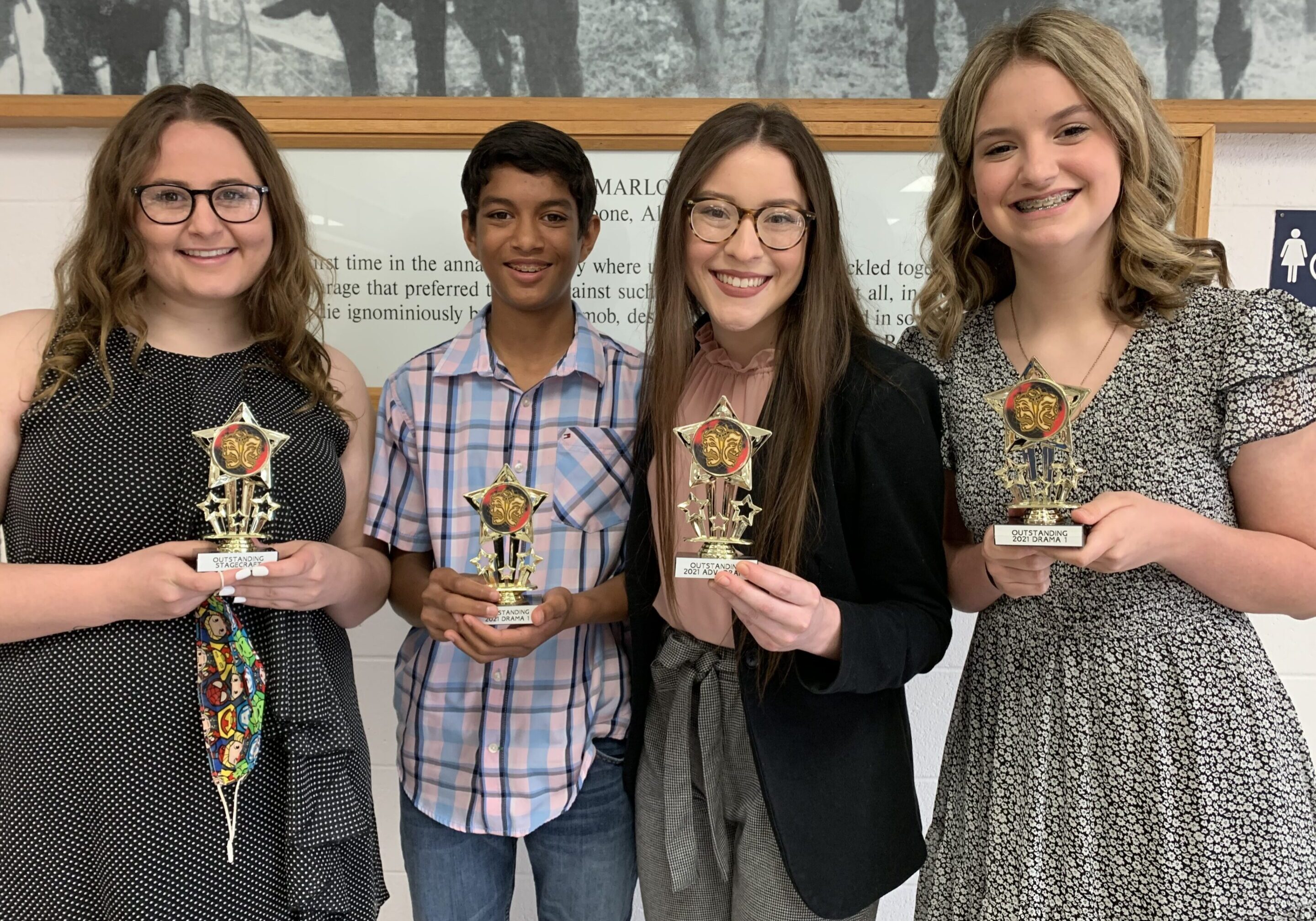 Group holding trophies and smiling
