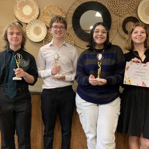 Smiling students with awards