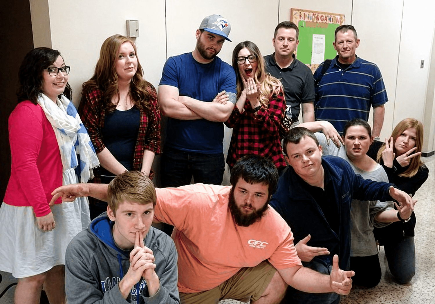 Group of people posing playfully indoors.